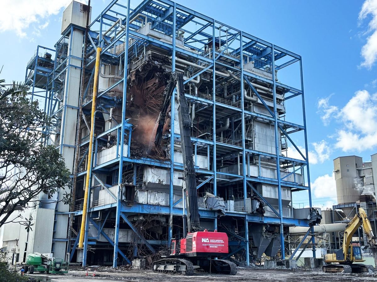 NADC high-reach excavator dismantling an industrial boiler structure