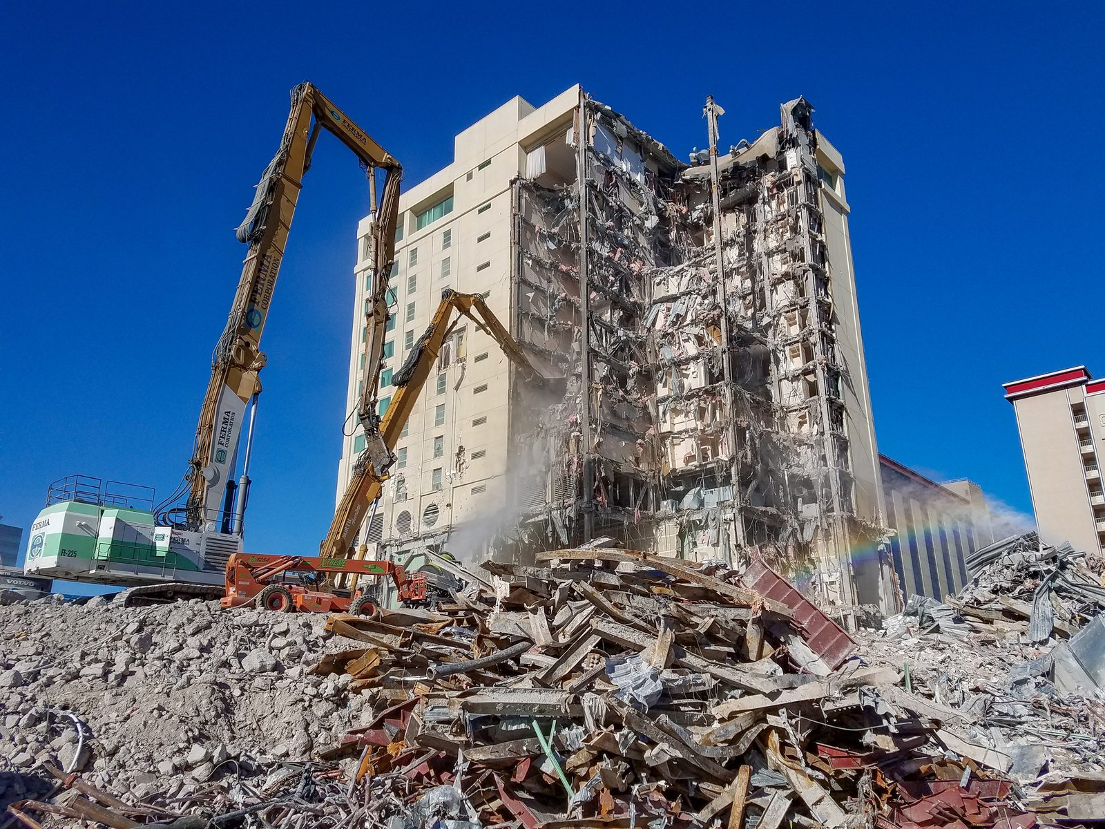 High-reach excavator dismantling the Las Vegas Club tower bay by bay