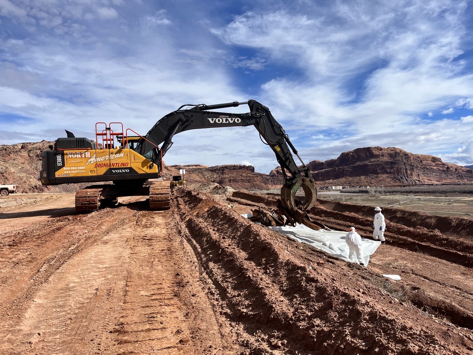 Excavator excavating buried debris at the Moab uranium mill tailings remedial action site