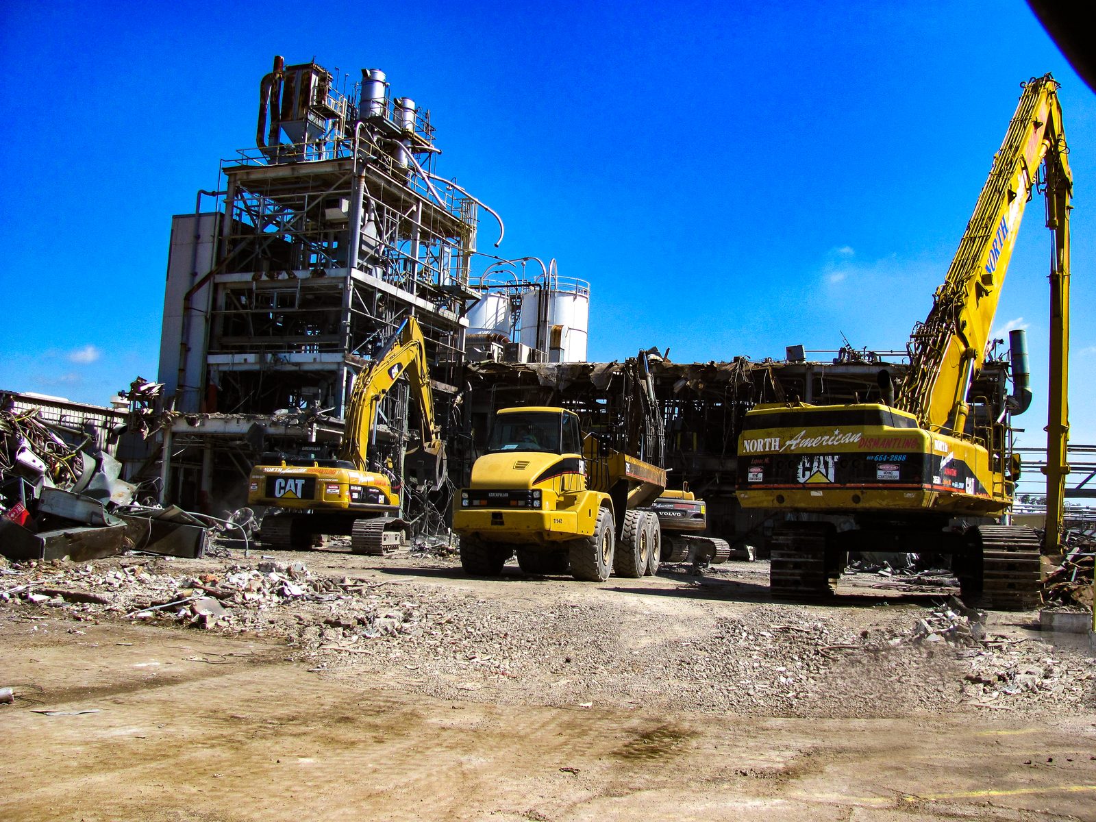 Excavators processing debris during demolition of the SABIC plastics manufacturing plant