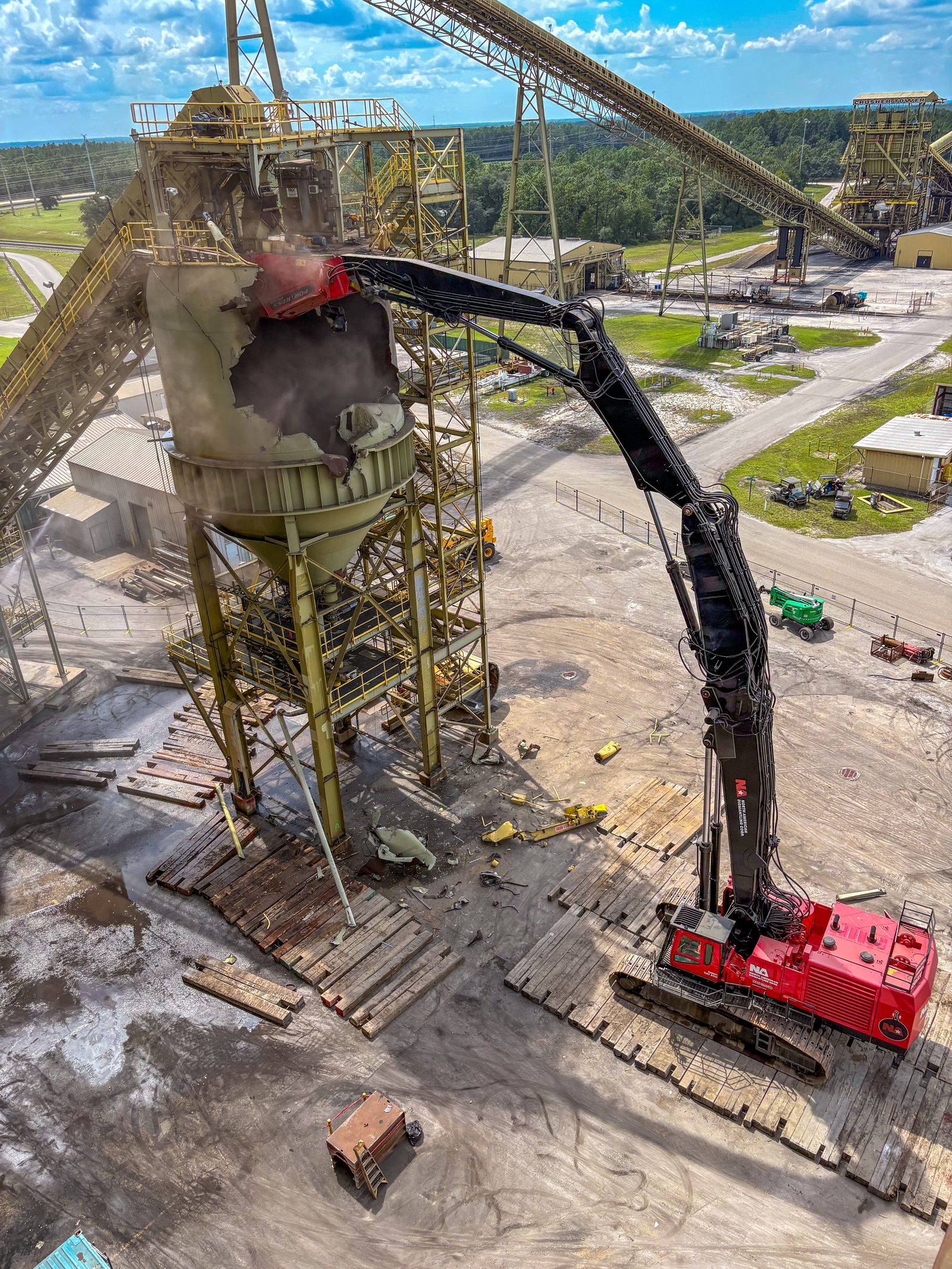 NADC crew and high-reach excavator working inside an active industrial facility